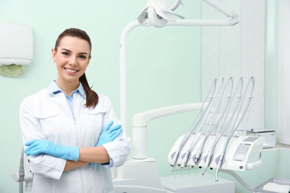 dentista mulher ao lado de seus instrumentos odontológicos